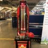 King of the Hammer high striker arcade game with red mallet set up at a DPD depot event